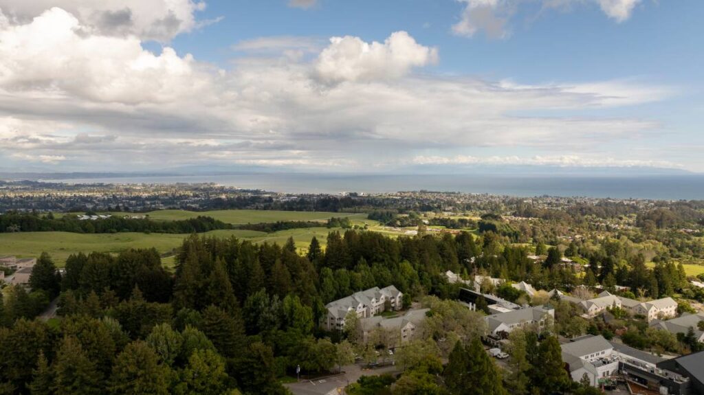 An aerial view of the campus and coastline near Santa Cruz, representing Santa Cruz County real estate
